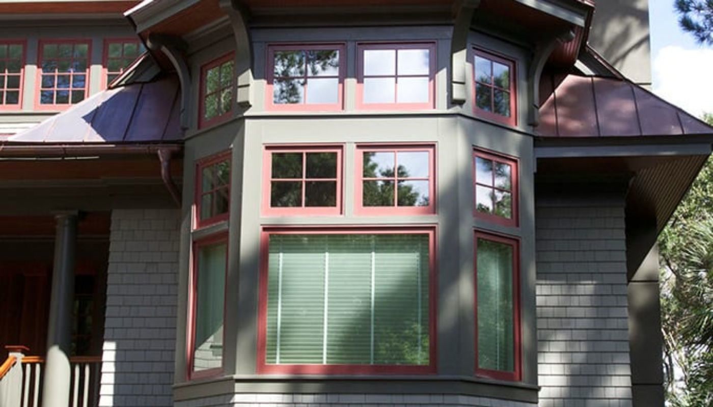 Bay window with red-trimmed multi-pane windows on a Charleston-area home