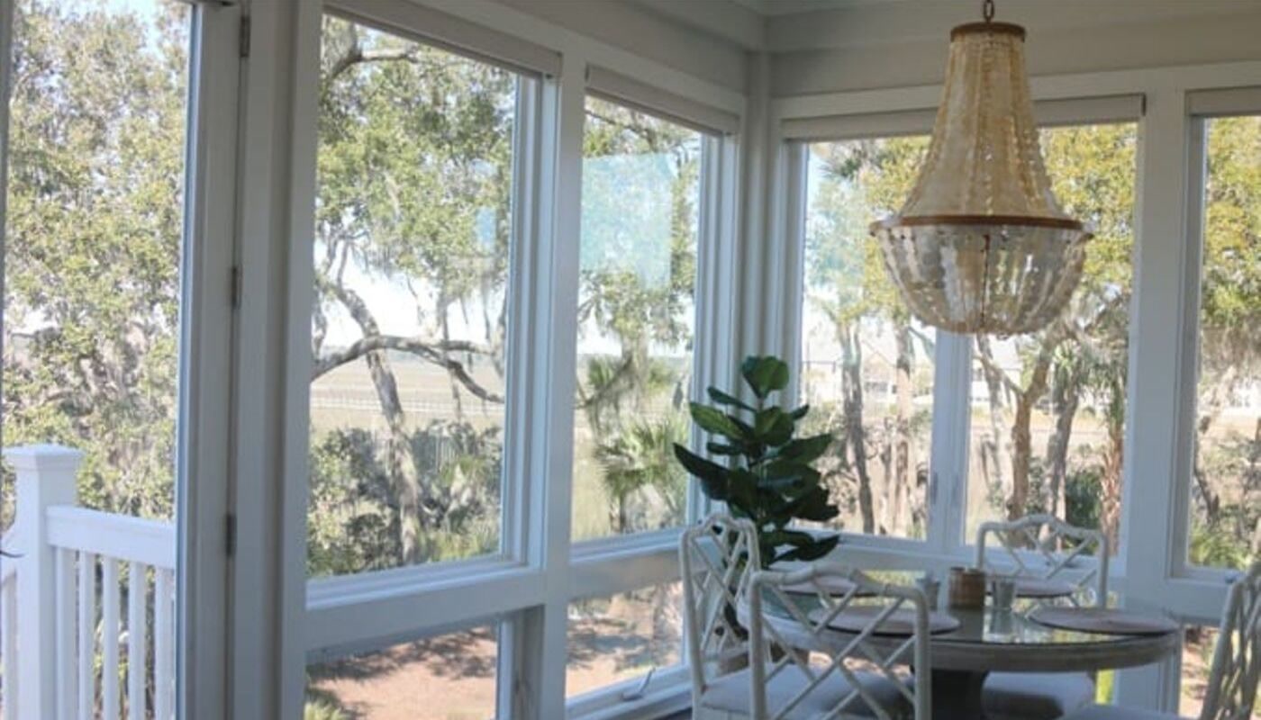 Inside a Muhler sunroom with marsh views Inside a Muhler sunroom with floor-to-ceiling windows overlooking the Lowcountry marsh