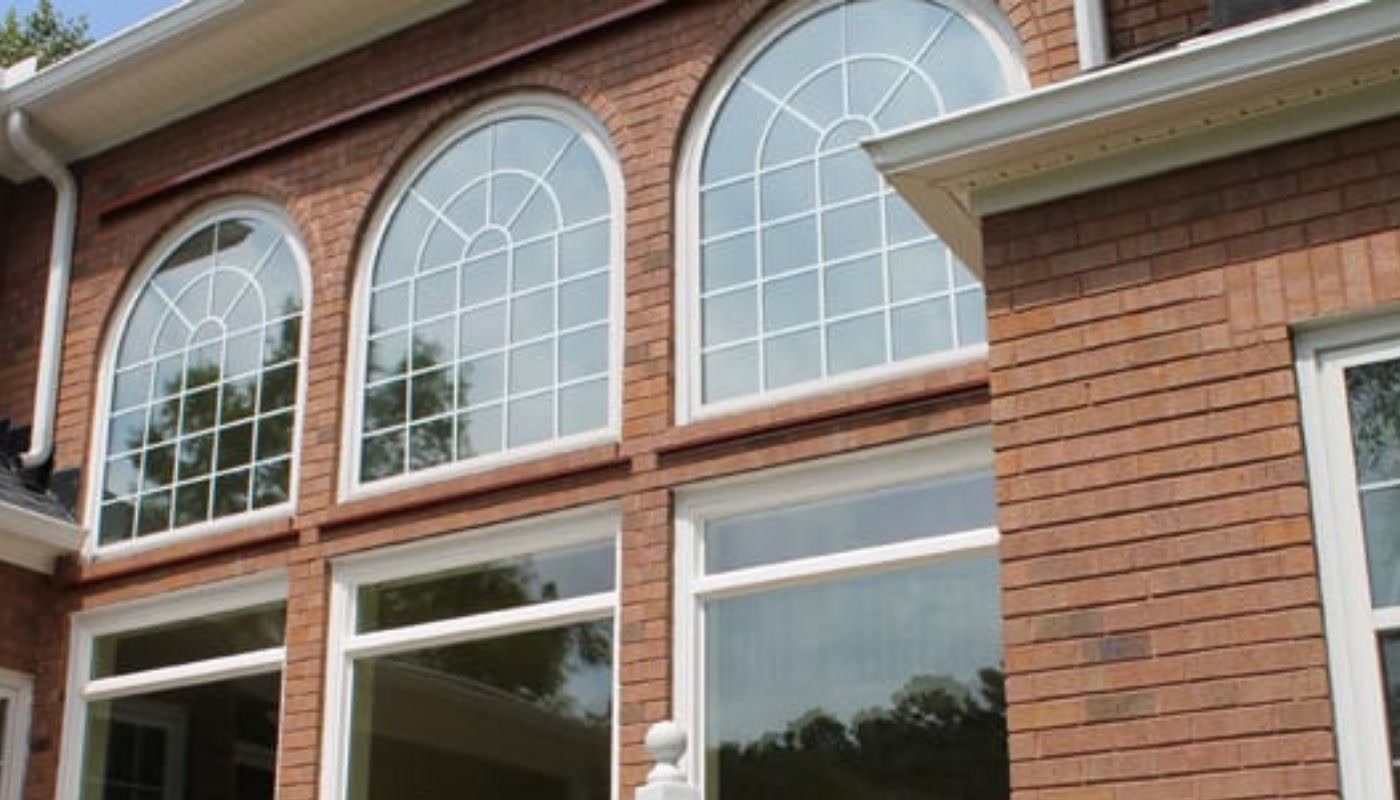 Custom arched replacement windows on a brick Charleston-area home installed by Muhler Custom arched replacement windows on a brick Charleston-area home installed by Muhler